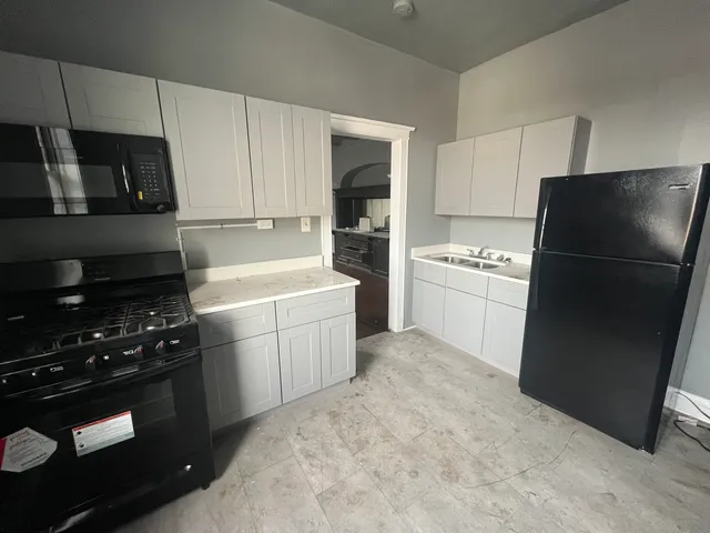 a kitchen with a sink stove and refrigerator