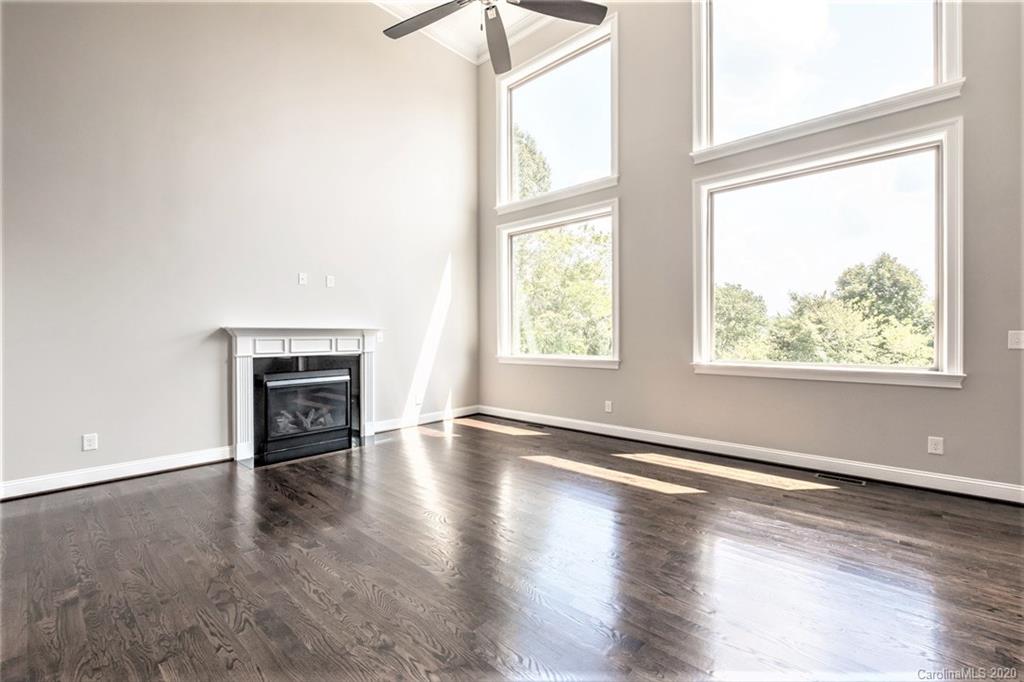 133 Overlook Ridge Lane Davidson, NC 28036 - Photo 11 of 35 an empty room with wooden floor and windows