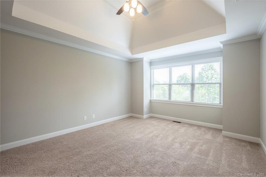 133 Overlook Ridge Lane Davidson, NC 28036 - Photo 15 of 35 an empty room with a chandelier fan and windows