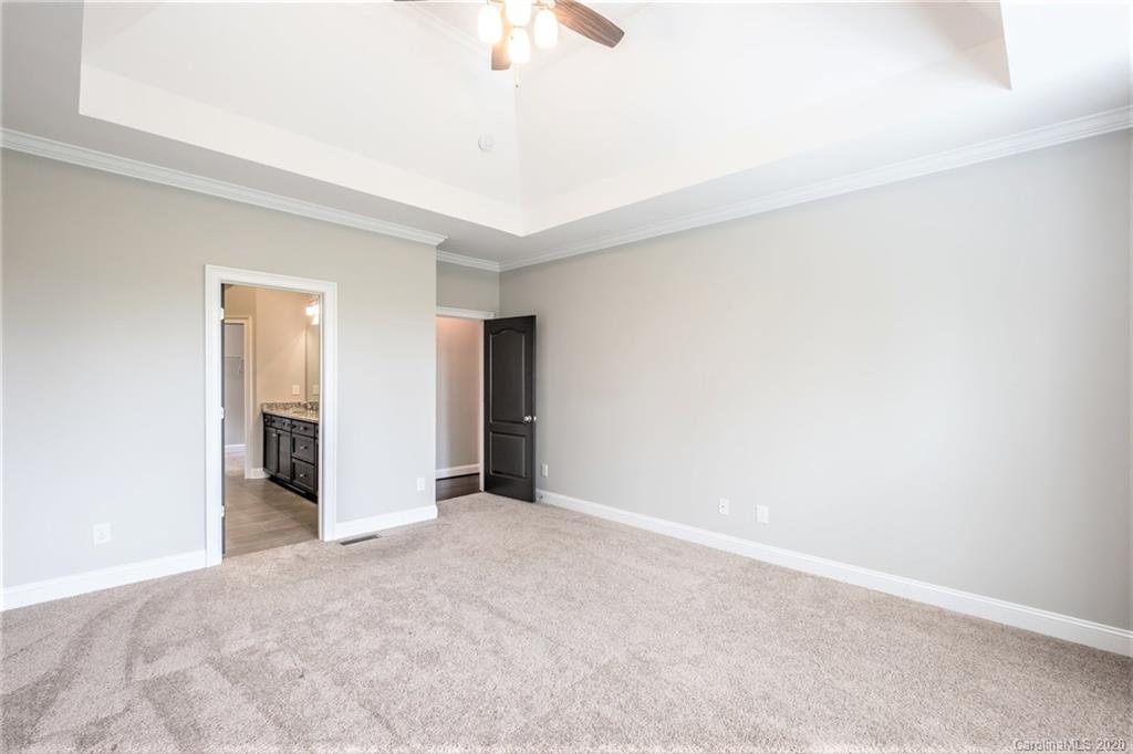 133 Overlook Ridge Lane Davidson, NC 28036 - Photo 16 of 35 an empty room with closet and a chandelier fan