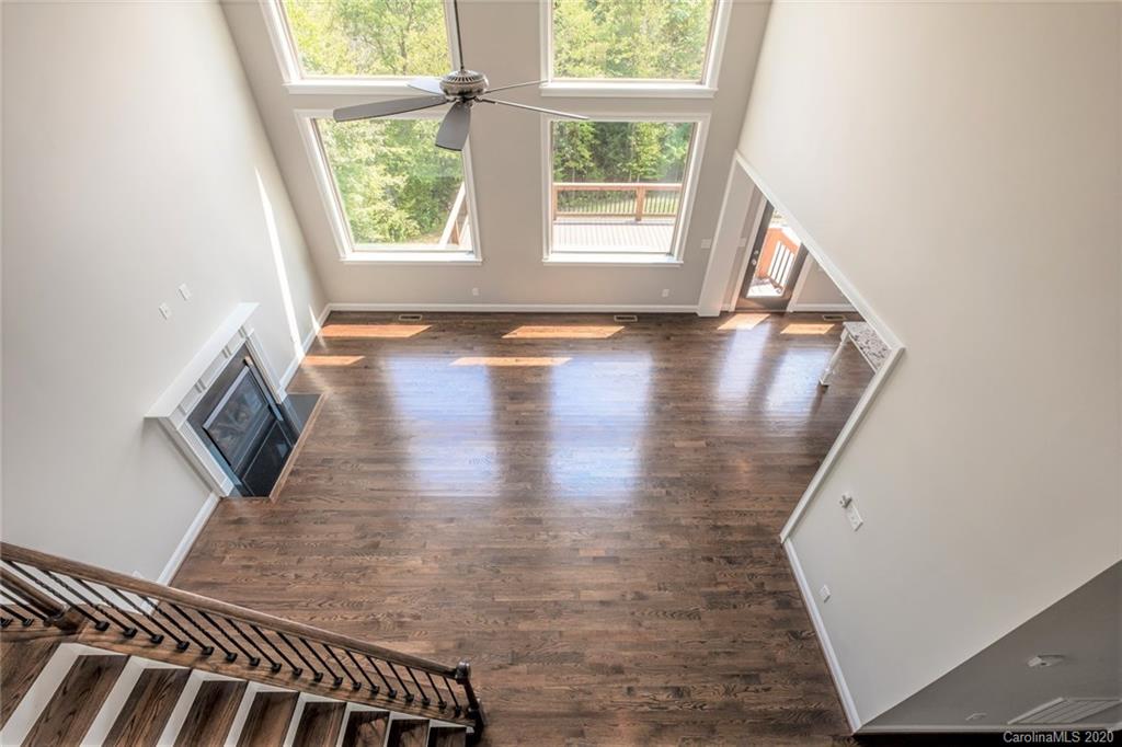 133 Overlook Ridge Lane Davidson, NC 28036 - Photo 26 of 35 a view of a hallway with wooden floor and a bookshelf