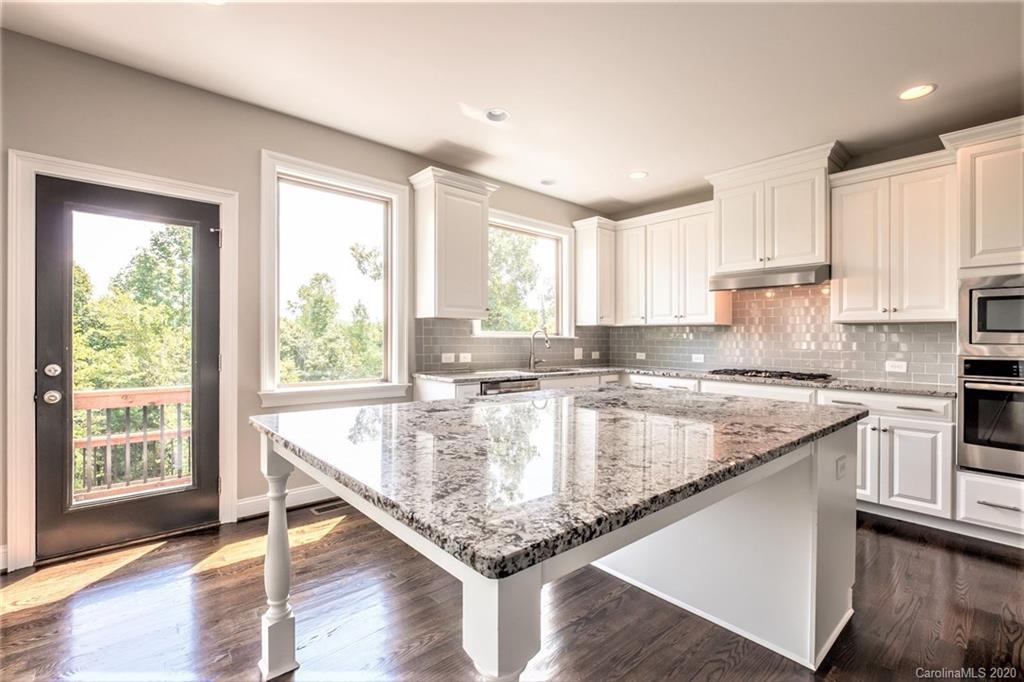 133 Overlook Ridge Lane Davidson, NC 28036 - Photo 4 of 35 a kitchen with stainless steel appliances granite countertop a stove a sink and a microwave