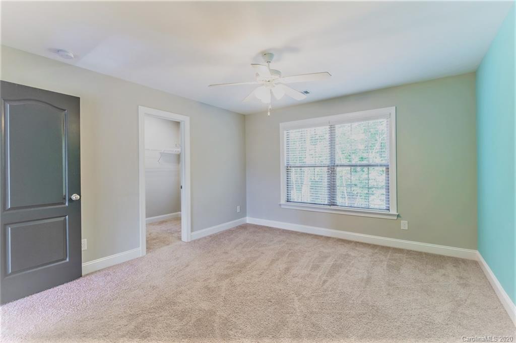 133 Overlook Ridge Lane Davidson, NC 28036 - Photo 31 of 35 an empty room with chandelier fan and windows
