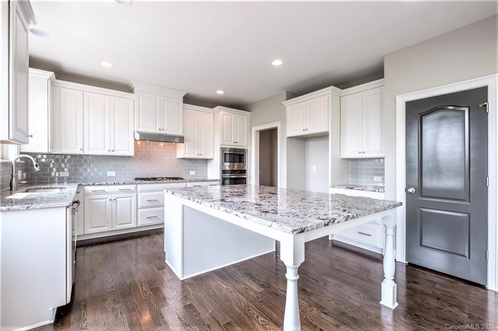 133 Overlook Ridge Lane Davidson, NC 28036 - Photo 5 of 35 a kitchen with stainless steel appliances granite countertop a stove refrigerator sink and cabinets