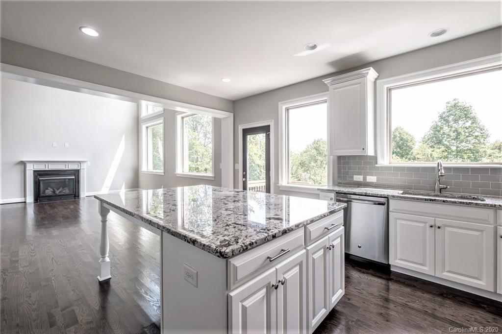 133 Overlook Ridge Lane Davidson, NC 28036 - Photo 7 of 35 a kitchen with granite countertop a sink and a window