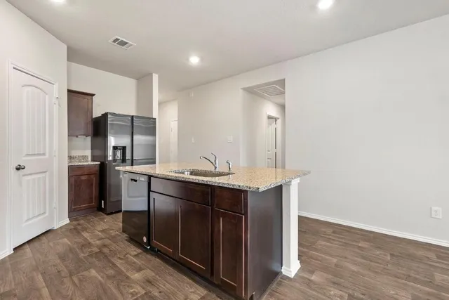 a kitchen with stainless steel appliances a sink and refrigerator