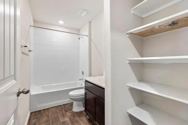 a bathroom with a toilet and a shower