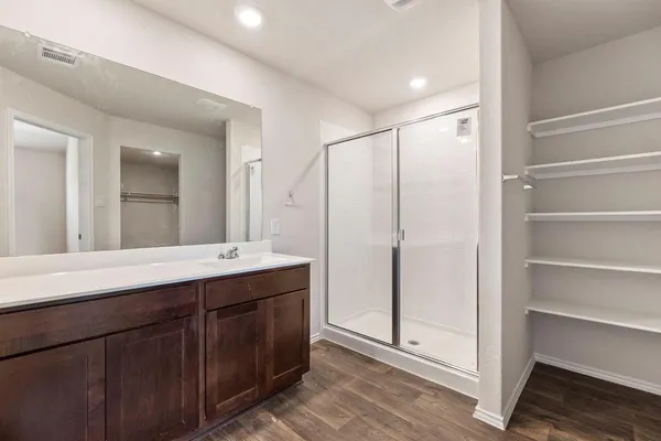 a bathroom with a double vanity sink mirror and shower