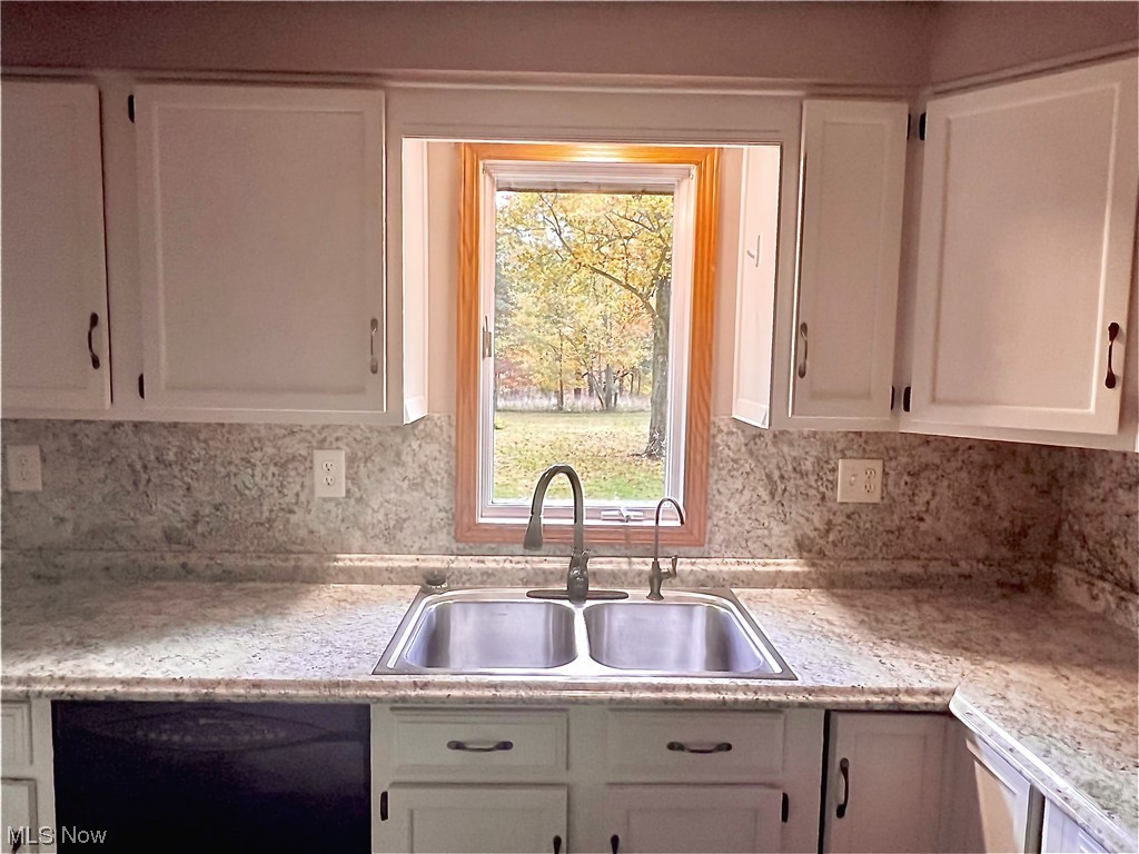 3122 Bedrock Road Northwest Dellroy, OH 44620 - Photo 14 of 23 Kitchen featuring a healthy amount of sunlight, white cabinets, and sink