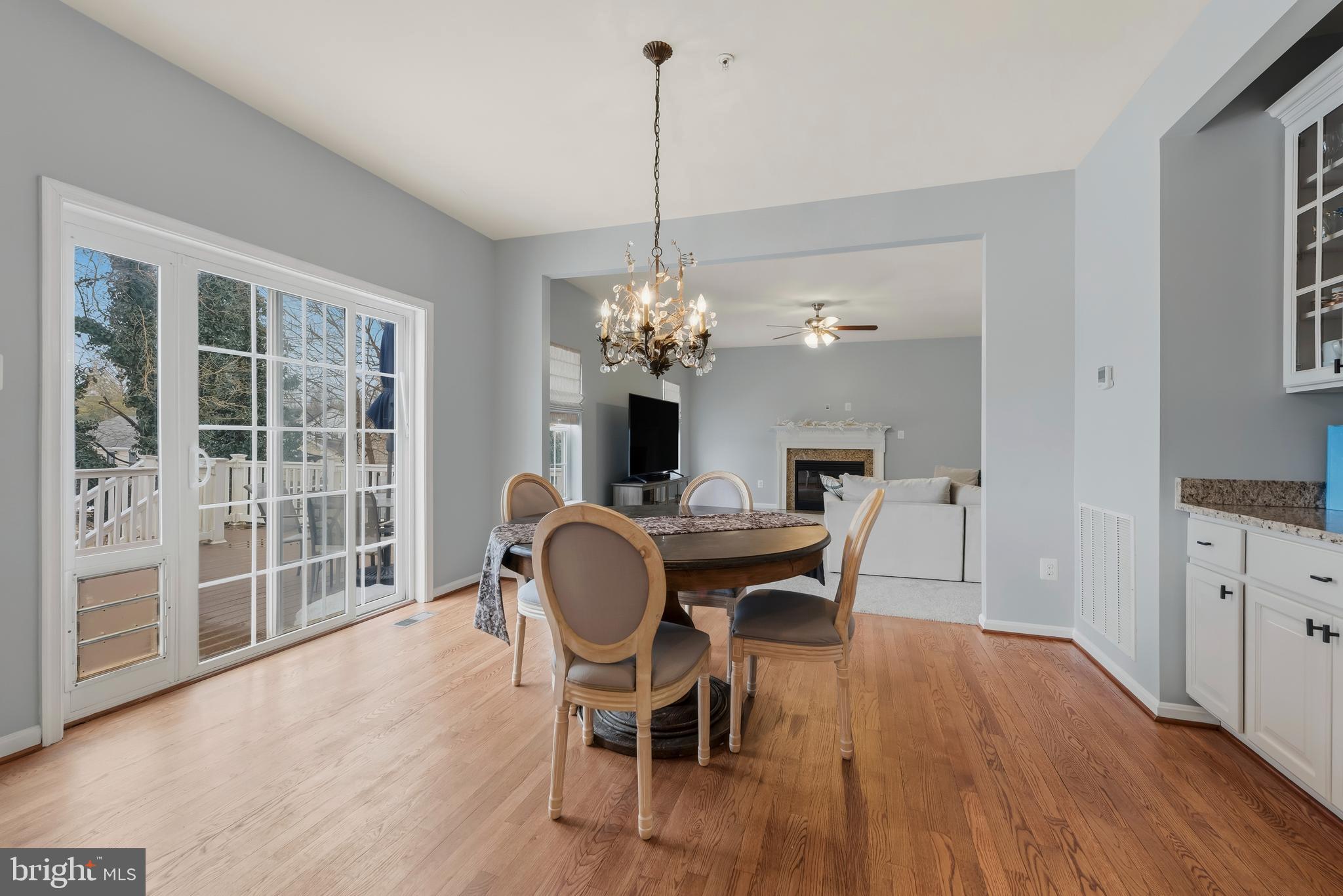 3007 Bender Ridge Court Baltimore, MD 21234 - Photo 11 of 39 a dining room with furniture a chandelier and wooden floor