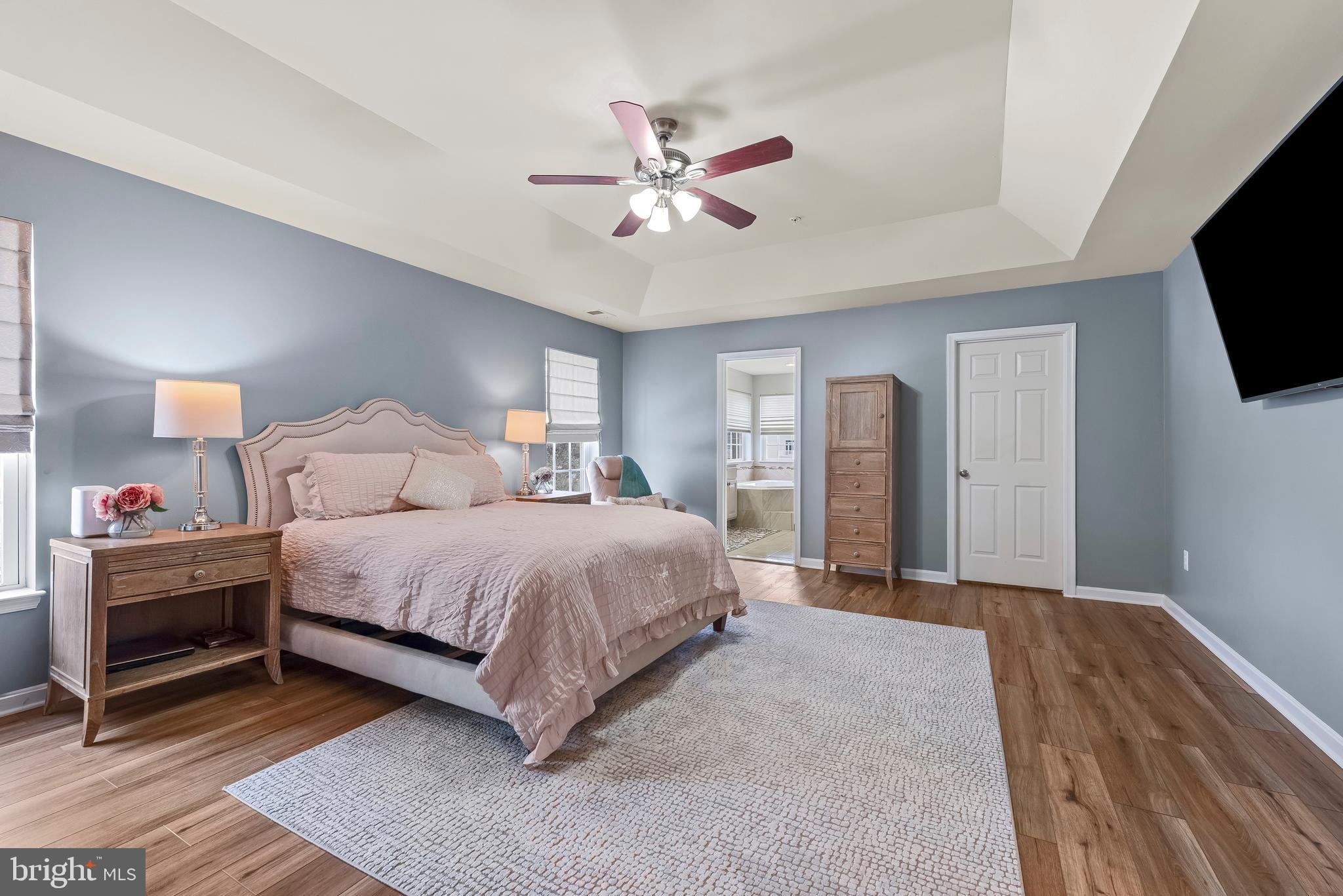 3007 Bender Ridge Court Baltimore, MD 21234 - Photo 16 of 39 a spacious bedroom with a bed and a flat screen tv