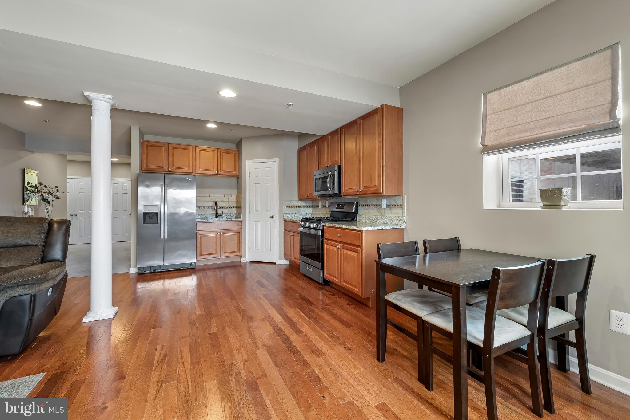 3007 Bender Ridge Court Baltimore, MD 21234 - Photo 27 of 39 a kitchen with granite countertop wooden floors and stainless steel appliances