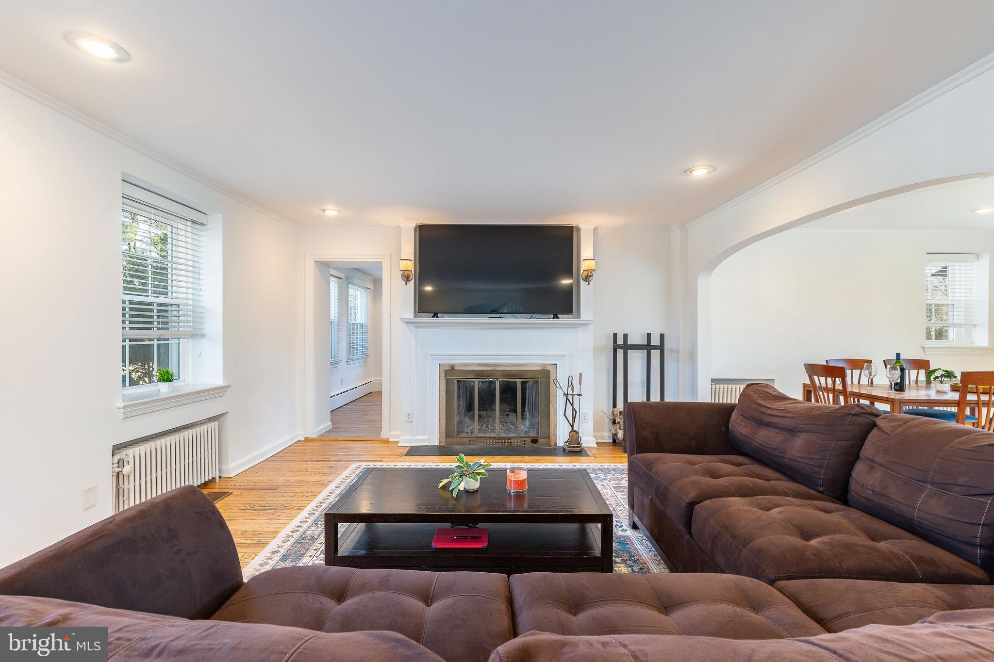 1208 Andover Road Wynnewood, PA 19096 - Photo 12 of 31 a living room with furniture a flat screen tv and a fireplace