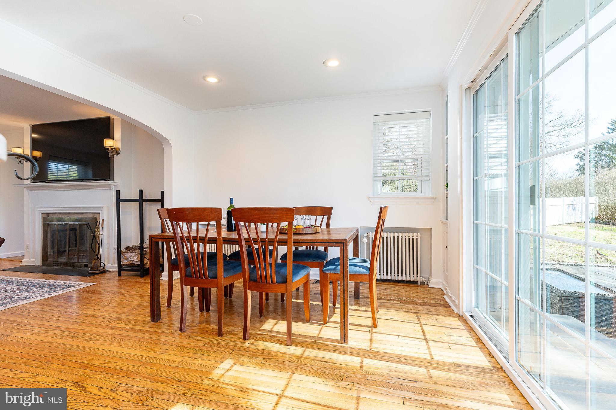 1208 Andover Road Wynnewood, PA 19096 - Photo 14 of 31 a dining room with furniture floor to ceiling windows and a flat screen tv