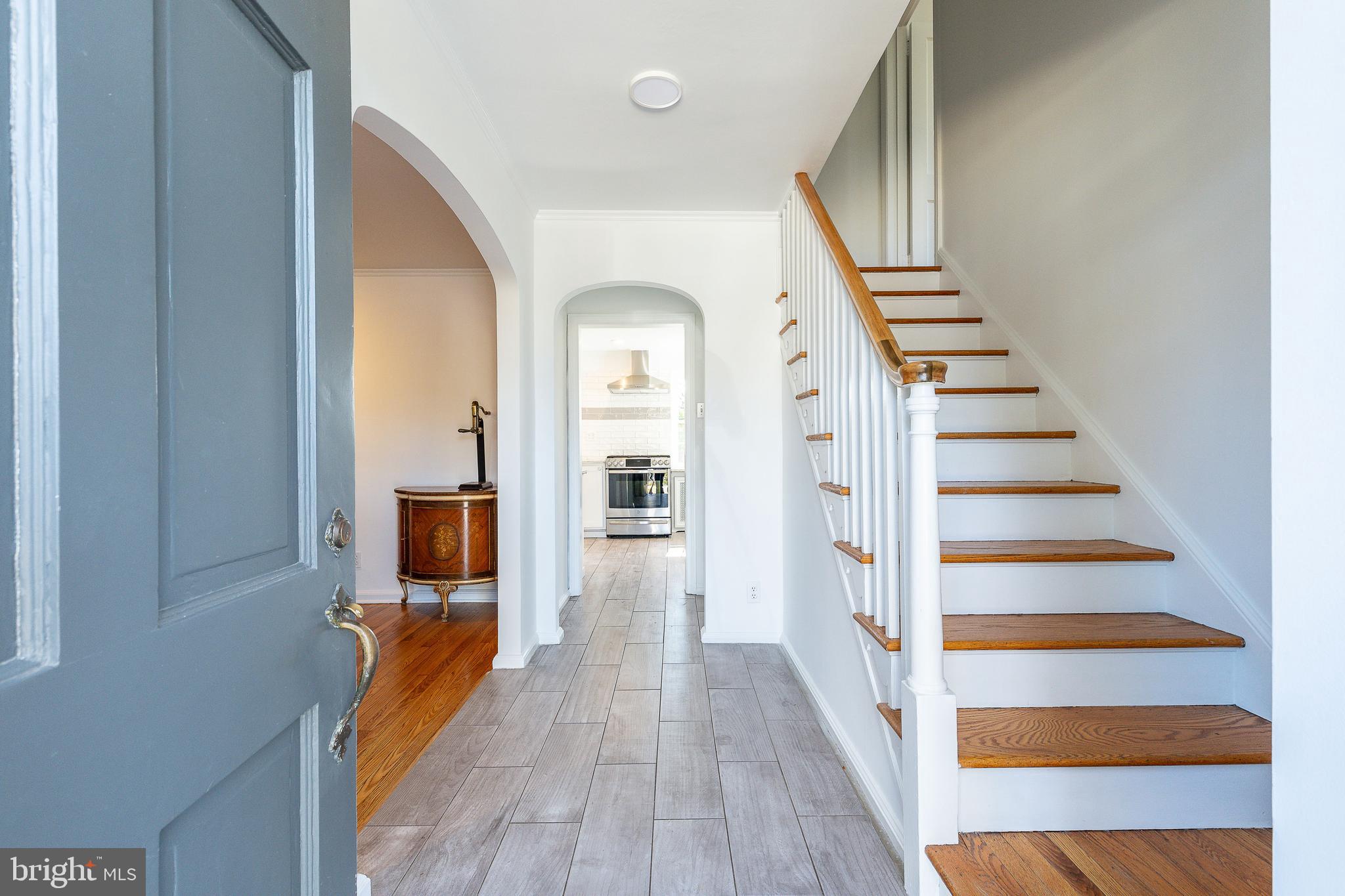 1208 Andover Road Wynnewood, PA 19096 - Photo 7 of 31 a view of a hallway with wooden floor and staircase
