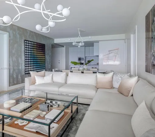 a living room with furniture kitchen and a chandelier