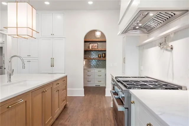 a kitchen with stainless steel appliances a cabinets and wooden floor