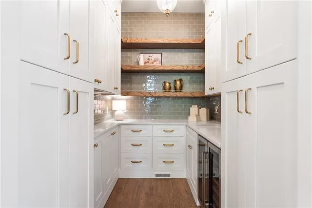 a bathroom with a sink a large mirror and vanity
