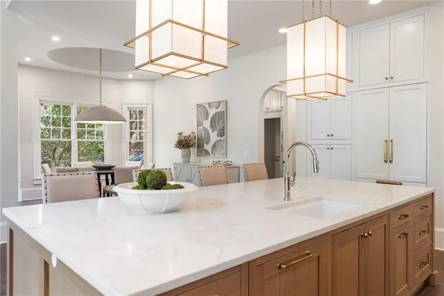 a living room with furniture a fireplace and a chandelier