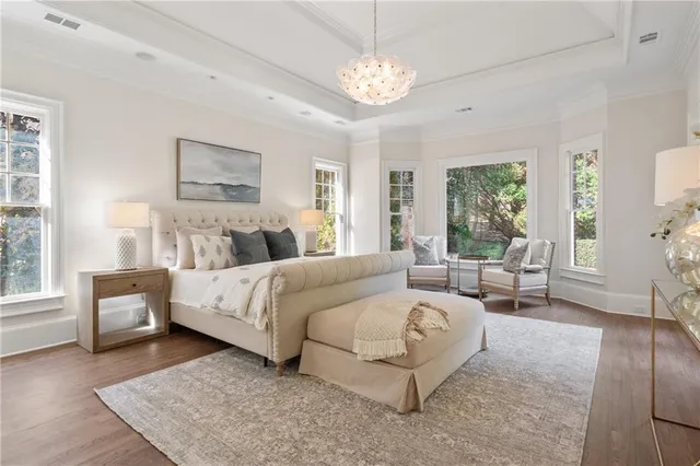 a bedroom with a large bed and ceiling fan
