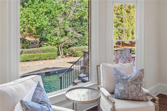 a spacious en suite bathroom with a double vanity sink a large mirror and a bathtub