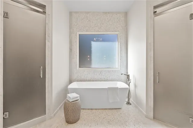 a bathroom with a tub sink and shower