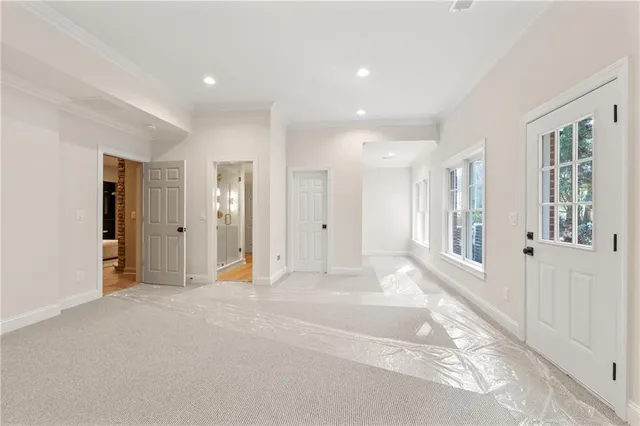 an empty room with windows and closet