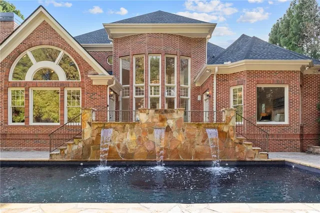 a view of a house with a yard and furniture
