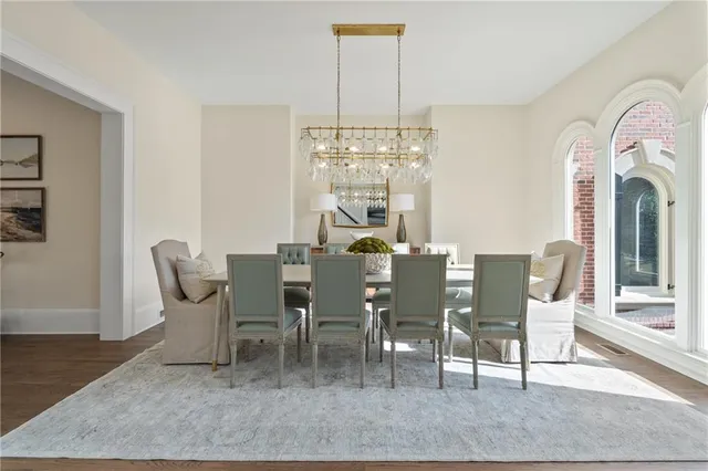 a living room with furniture a fireplace and a large window