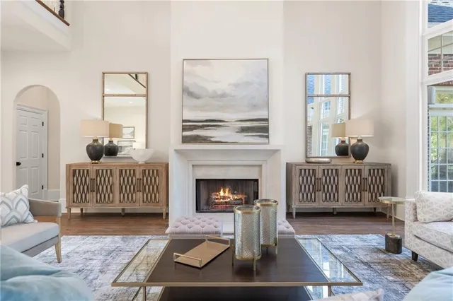 a living room with furniture a fireplace and a flat screen tv
