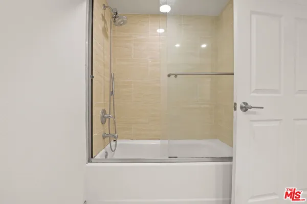 a bathroom with a bathtub and a shower