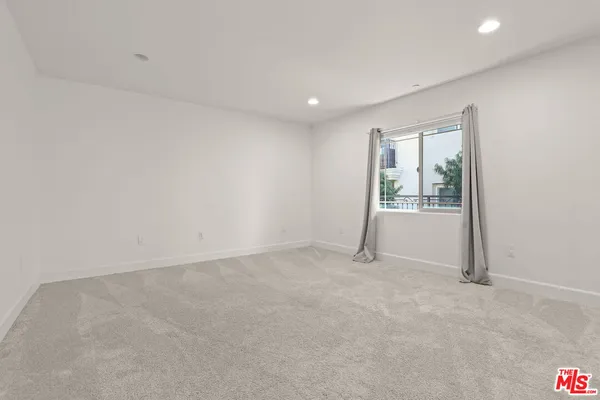 a view of an empty room with glass door