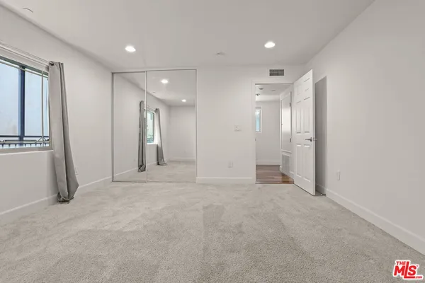 a bathroom with a granite countertop sink a toilet and shower