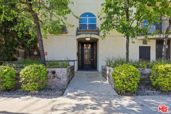 front view of a house with a yard and an trees