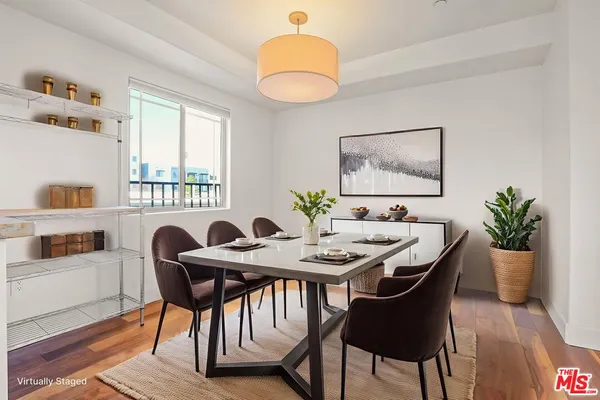 a view of a dining room with furniture and chandelier