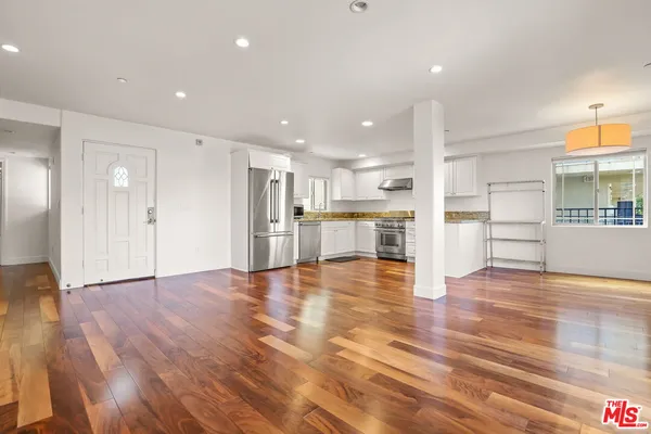 a view of a kitchen with wooden floor and a kitchen