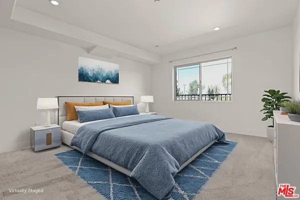 a bedroom with bed and a potted plant