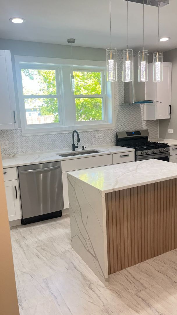 1201 South 15th Avenue Maywood, IL 60153 - Photo 8 of 28 a kitchen with stainless steel appliances granite countertop a sink a stove a kitchen island with wooden cabinets and floors
