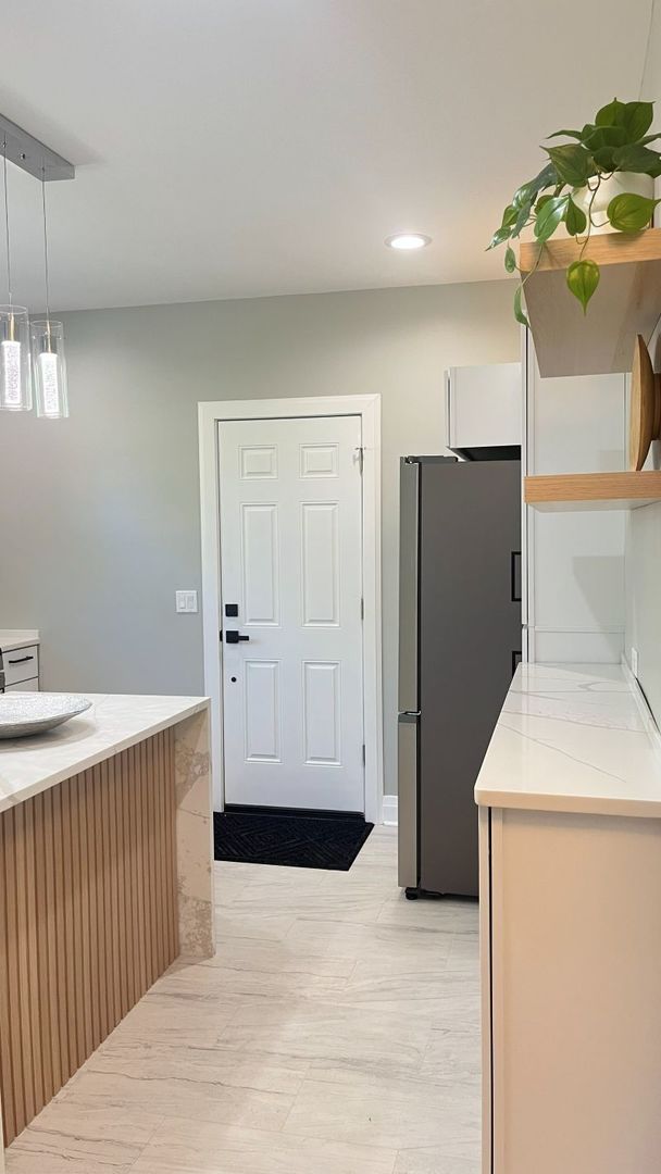 1201 South 15th Avenue Maywood, IL 60153 - Photo 9 of 28 a view of a kitchen with a sink cabinet and a refrigerator