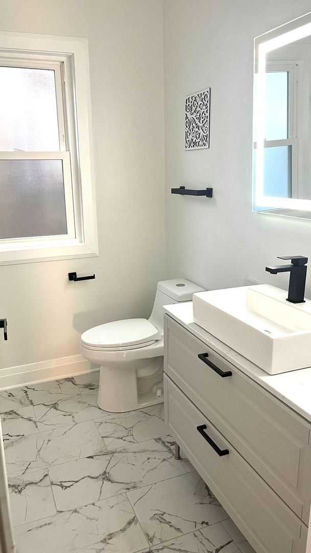 1201 South 15th Avenue Maywood, IL 60153 - Photo 11 of 28 a bathroom with a sink toilet and mirror
