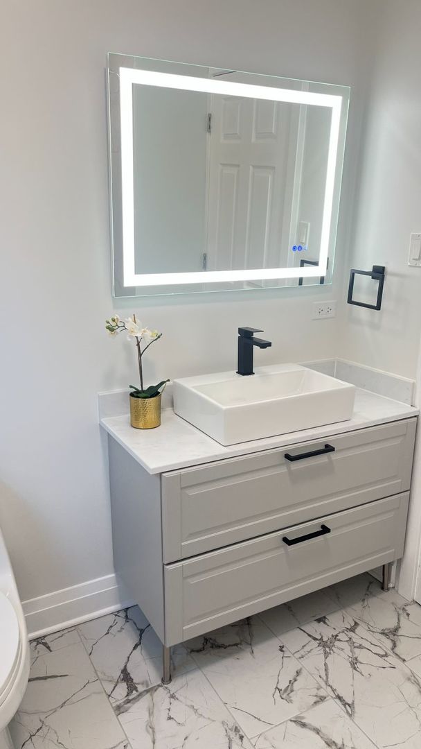 1201 South 15th Avenue Maywood, IL 60153 - Photo 12 of 28 a bathroom with a sink and a mirror