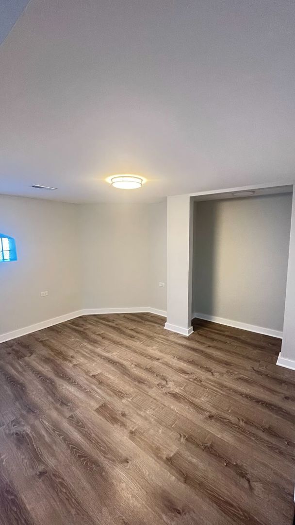 1201 South 15th Avenue Maywood, IL 60153 - Photo 20 of 28 a view of an empty room with wooden floor