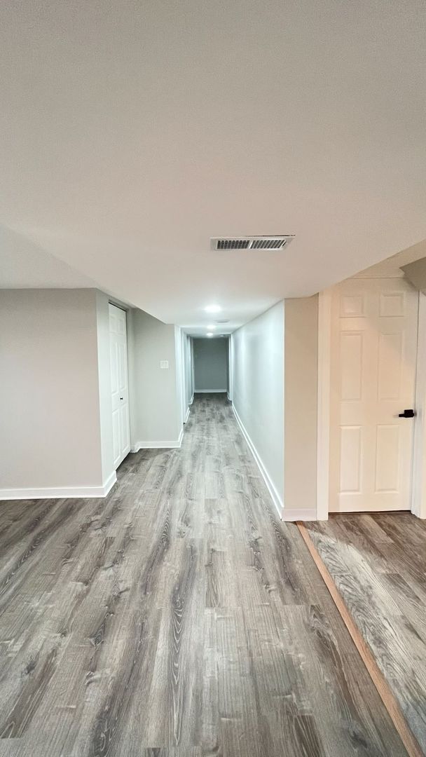 1201 South 15th Avenue Maywood, IL 60153 - Photo 22 of 28 a view of empty room with wooden floor