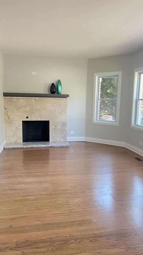 1201 South 15th Avenue Maywood, IL 60153 - Photo 4 of 28 a view of an empty room with wooden floor and a window