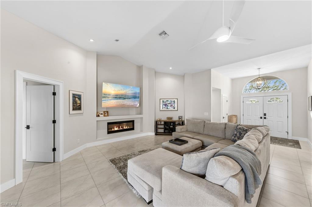 4724 Riverside Drive Estero, FL 33928 - Photo 6 of 44 a living room with furniture a fireplace and a flat screen tv