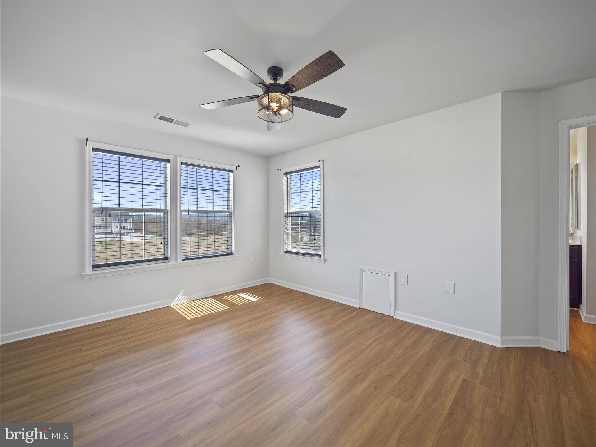 1142 Stallion Street Ranson, WV 25438 - Photo 21 of 31 a view of an empty room with wooden floor and a window