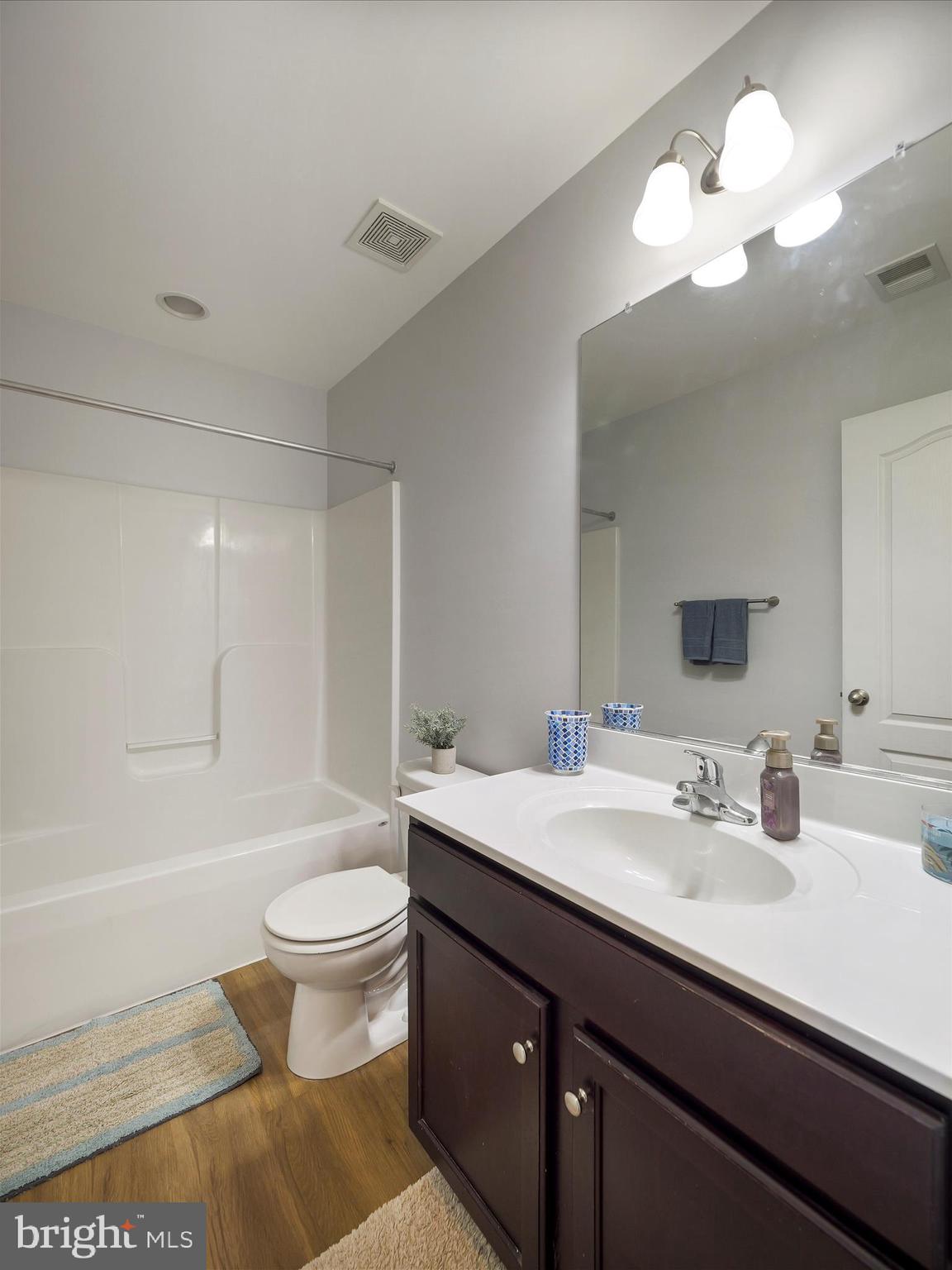 1142 Stallion Street Ranson, WV 25438 - Photo 29 of 31 a bathroom with a sink a toilet and a large mirror