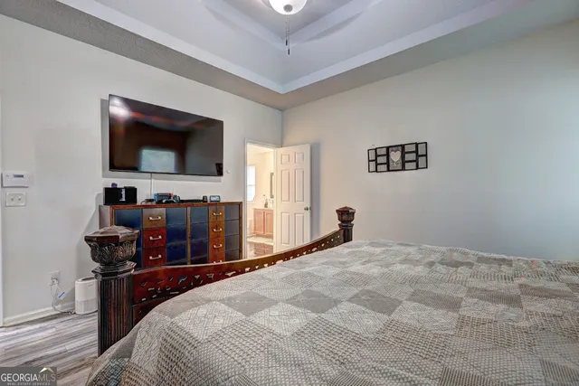 a bedroom with a bed and a flat screen tv