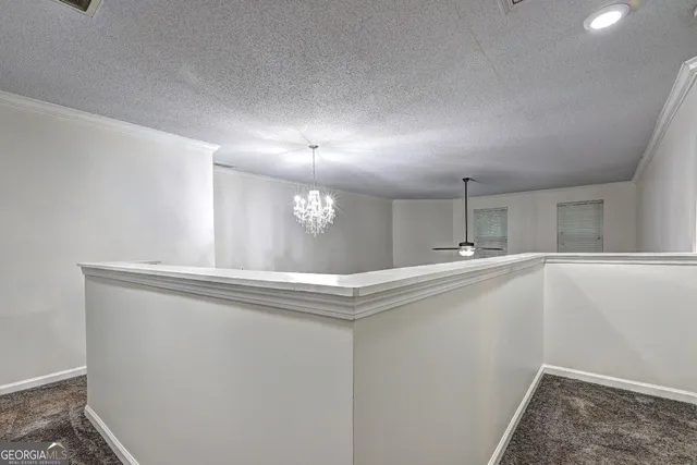 a bedroom with a bed and a flat tv screen on dresser