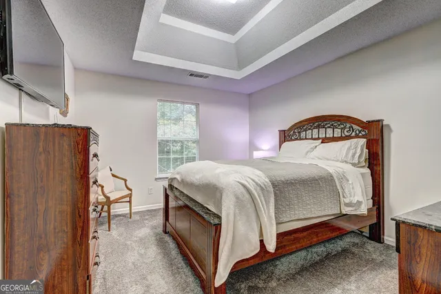 a bedroom with a bed and a flat screen tv